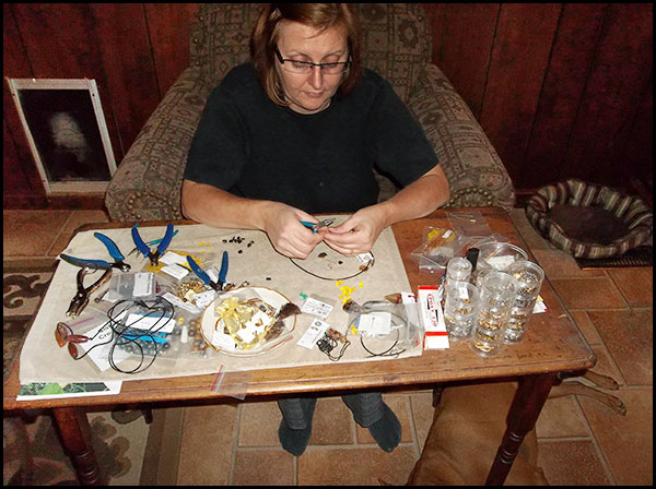 Anine is shown working at one of the jewelry assembly stations. Each jewelry creation is handmade to ensure perfection in every detail.